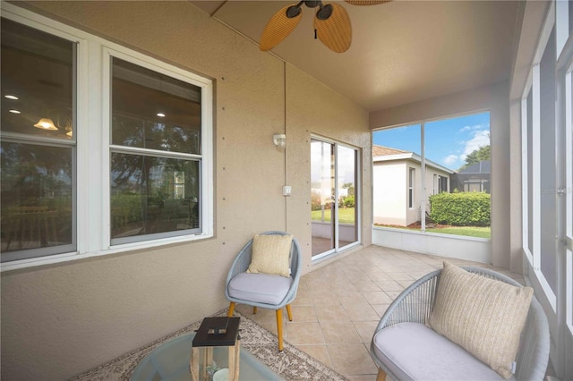 sunroom / solarium featuring ceiling fan