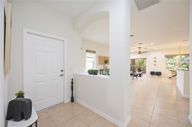 entryway featuring light tile patterned floors, a wealth of natural light, and visible vents