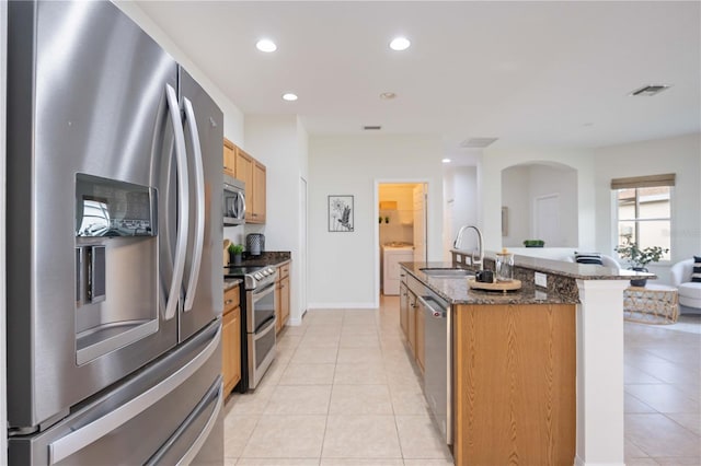 kitchen featuring light tile patterned floors, visible vents, appliances with stainless steel finishes, and a sink