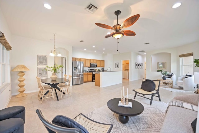 living room with ceiling fan, visible vents, and recessed lighting