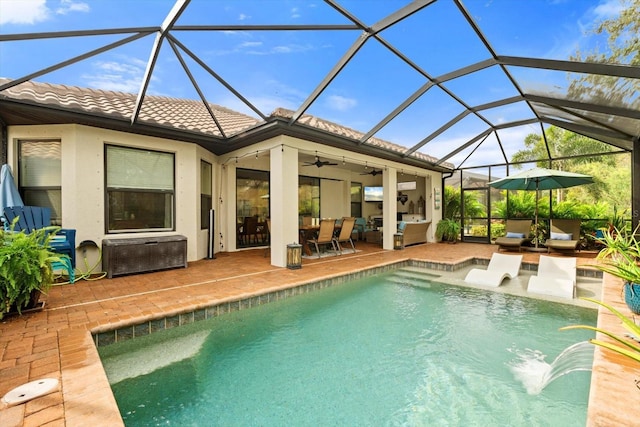 view of pool featuring ceiling fan, glass enclosure, an outdoor hangout area, and a patio