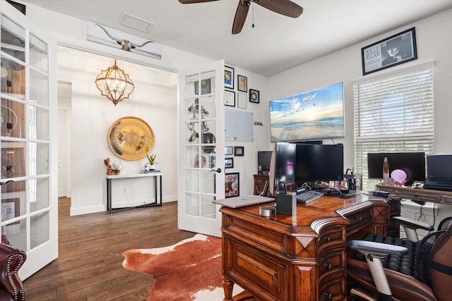 home office featuring dark hardwood / wood-style floors, ceiling fan with notable chandelier, and french doors