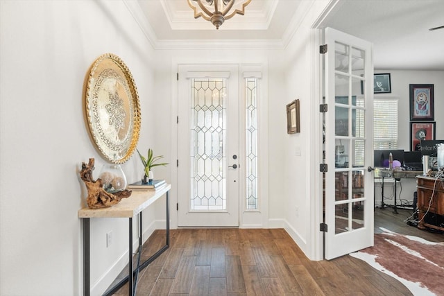 foyer entrance featuring crown molding and hardwood / wood-style flooring