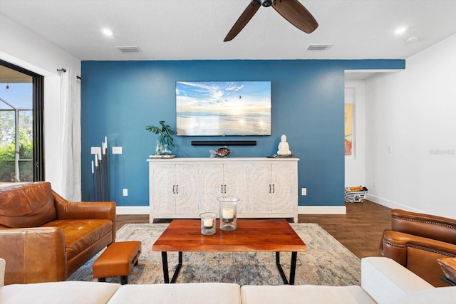 living room featuring ceiling fan and hardwood / wood-style floors