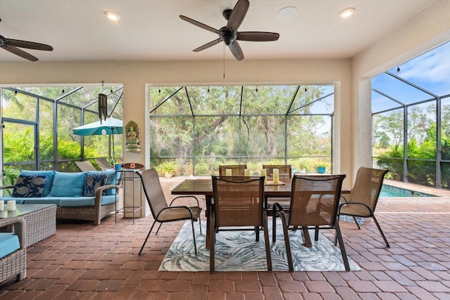 sunroom / solarium featuring ceiling fan and a swimming pool