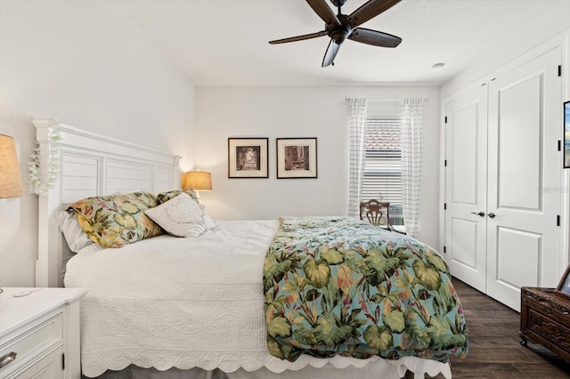 bedroom with ceiling fan, a closet, and dark hardwood / wood-style floors