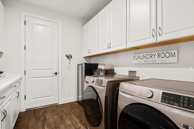 laundry room featuring cabinets, dark hardwood / wood-style flooring, and independent washer and dryer