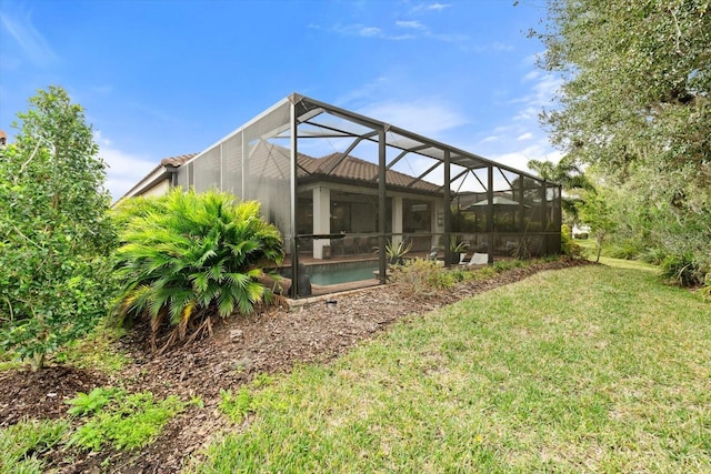 view of yard with glass enclosure