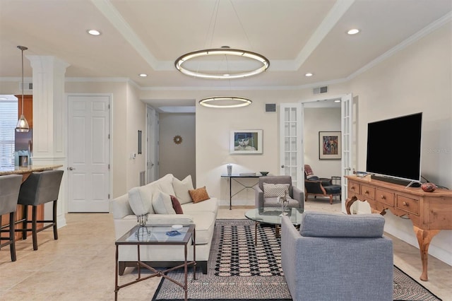 living room with crown molding, light tile patterned flooring, and a raised ceiling