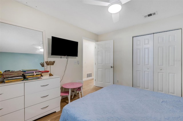 bedroom featuring light wood-type flooring, ceiling fan, and a closet