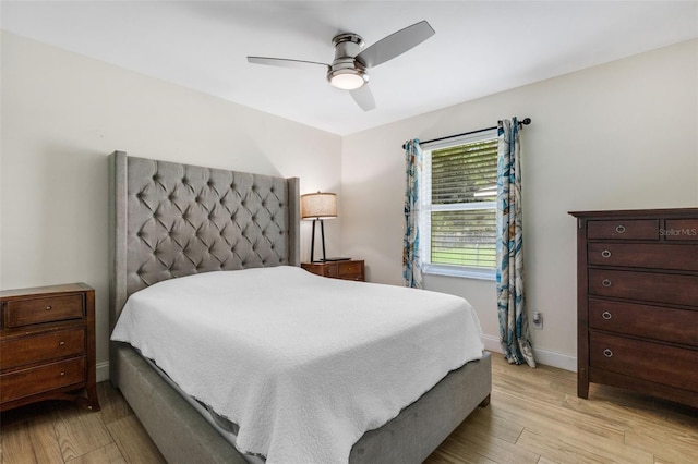 bedroom with ceiling fan and light hardwood / wood-style floors