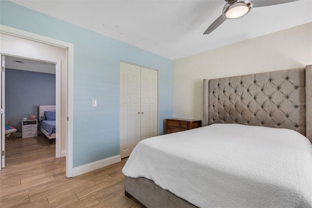 bedroom featuring light wood-type flooring, ceiling fan, and a closet