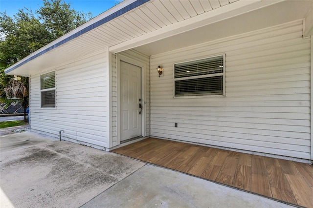 view of exterior entry featuring a patio area