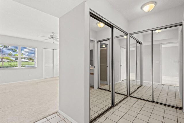 bathroom featuring ceiling fan and tile patterned flooring