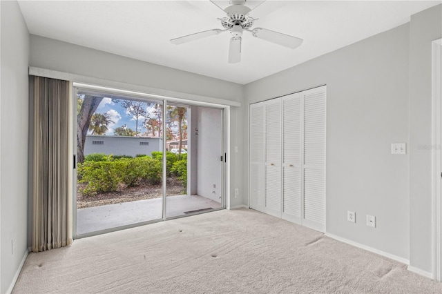 unfurnished bedroom featuring light colored carpet, access to exterior, and ceiling fan