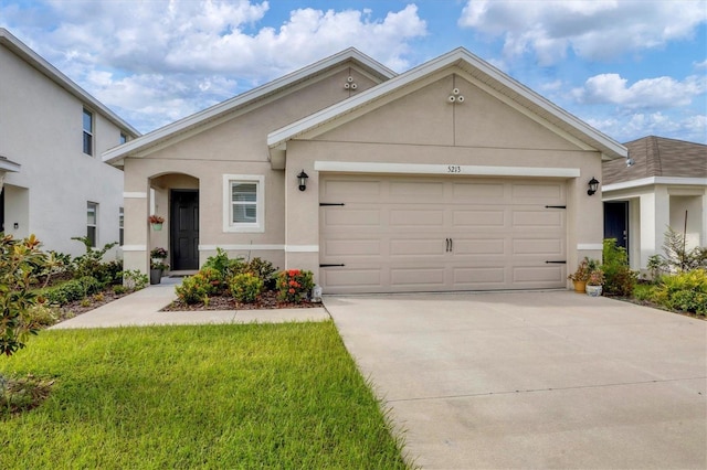 view of front of house featuring a front yard and a garage