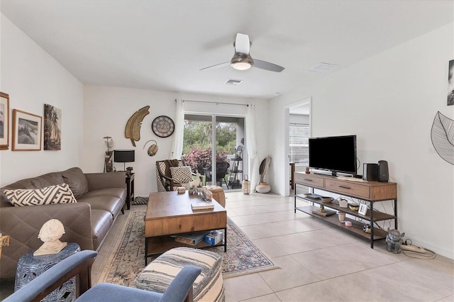 living room with ceiling fan and light tile patterned floors