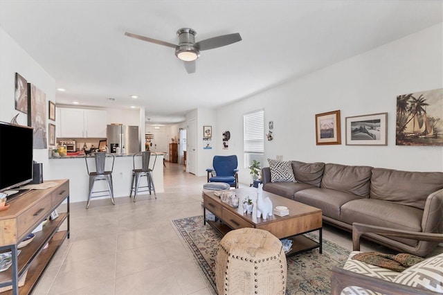 living room featuring ceiling fan and light tile patterned flooring