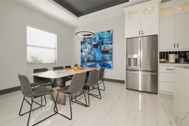 dining space featuring a tray ceiling