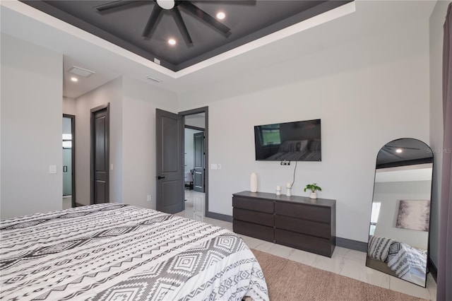 bedroom with a raised ceiling and ceiling fan