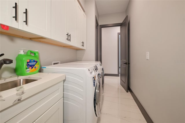 washroom featuring cabinets, separate washer and dryer, and sink