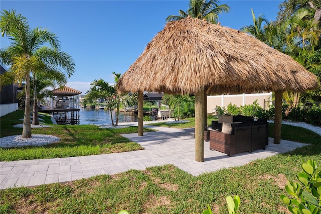 view of property's community with a water view and a gazebo