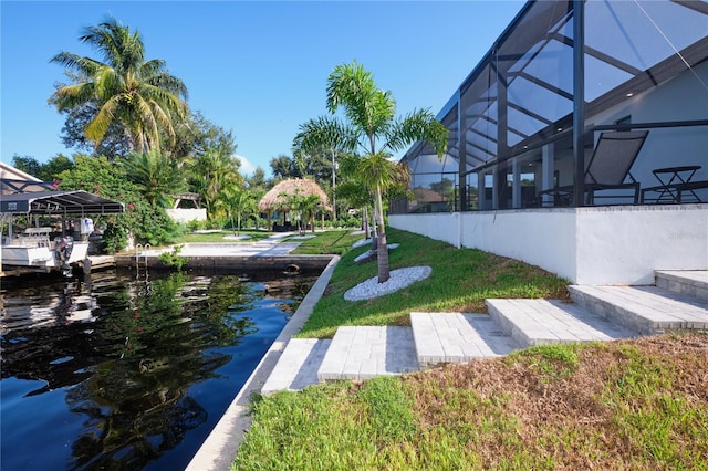 exterior space with a lanai and a water view