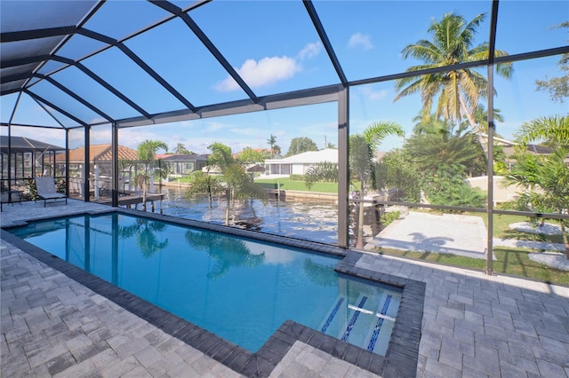 view of swimming pool featuring a patio area and a lanai