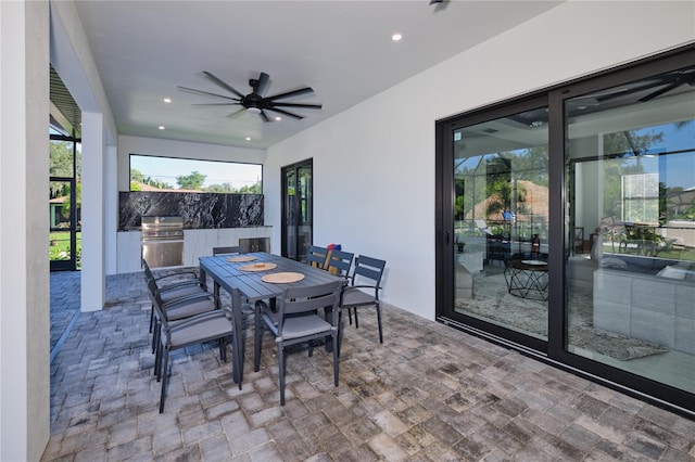 view of patio featuring a grill, area for grilling, and ceiling fan