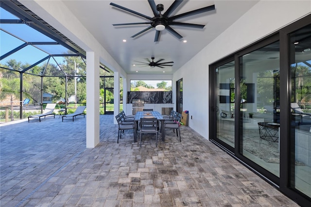 view of patio with glass enclosure and ceiling fan