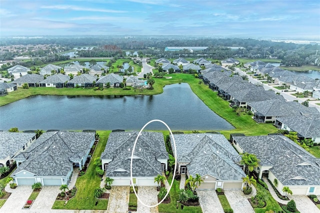 bird's eye view with a residential view and a water view