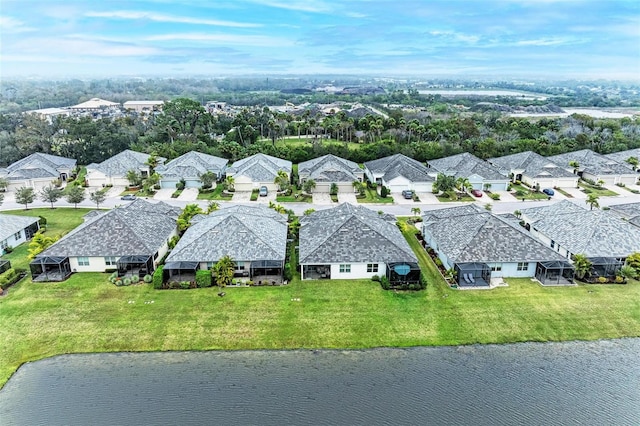 birds eye view of property featuring a residential view and a water view