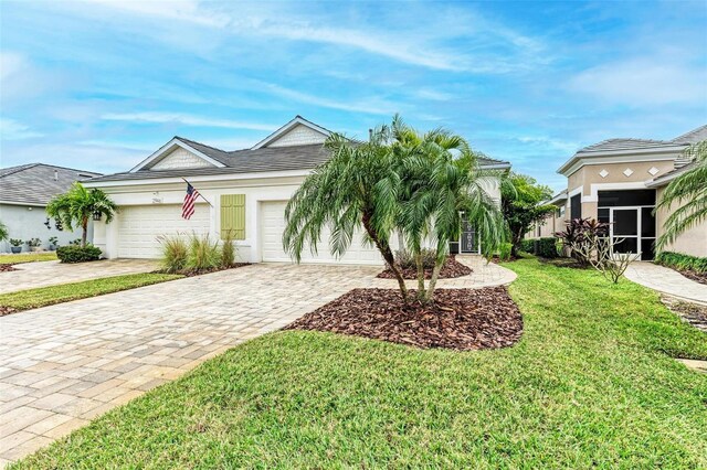 view of front of property featuring an attached garage, stucco siding, decorative driveway, and a front yard