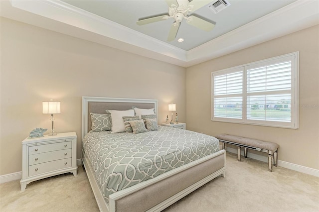 bedroom featuring a tray ceiling, baseboards, visible vents, and carpet flooring