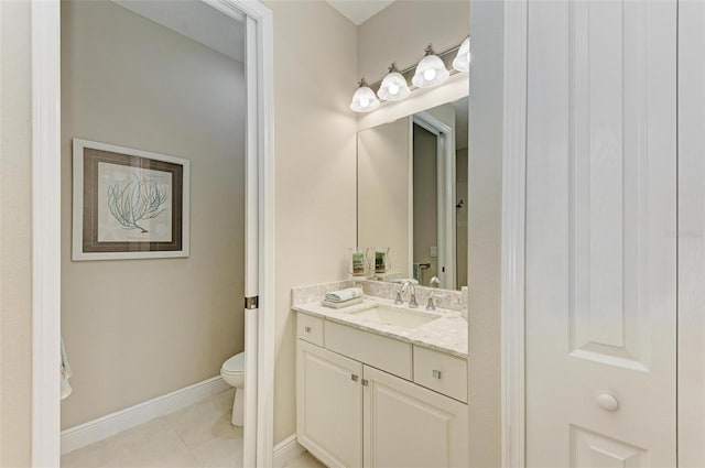 bathroom featuring tile patterned flooring, baseboards, vanity, and toilet