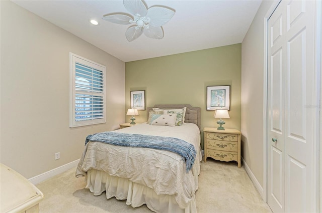 bedroom featuring light carpet, ceiling fan, and baseboards