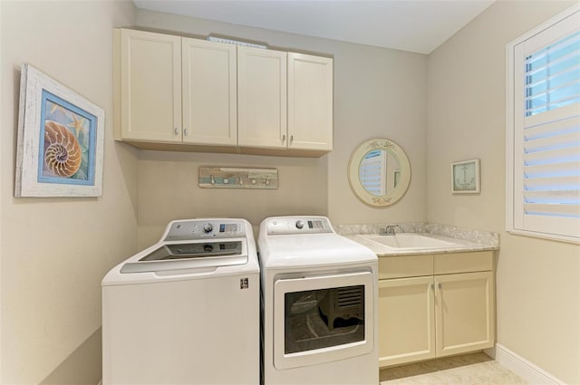 laundry room with independent washer and dryer, cabinet space, a sink, and baseboards