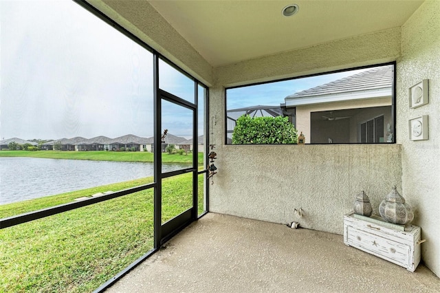 unfurnished sunroom featuring a water view