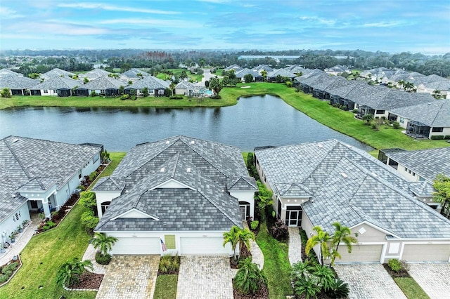 drone / aerial view featuring a residential view and a water view