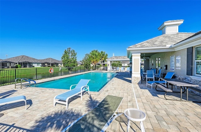 pool featuring a patio area and fence