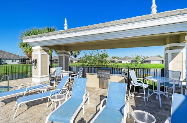 view of patio featuring fence, grilling area, area for grilling, and outdoor dining space