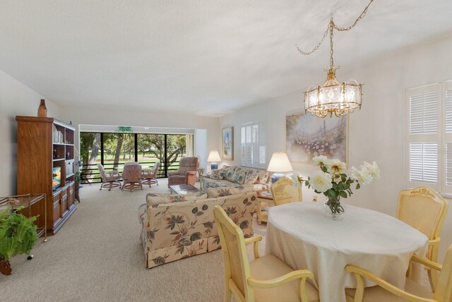 3500 El Conquistador Pkwy Unit 238, Bradenton, FL 34210 - living room featuring carpet floors and a chandelier