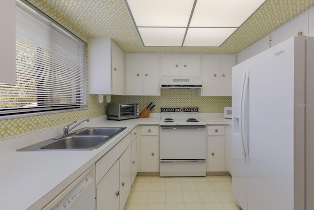 kitchen with sink, ventilation hood, white appliances, and white cabinetry