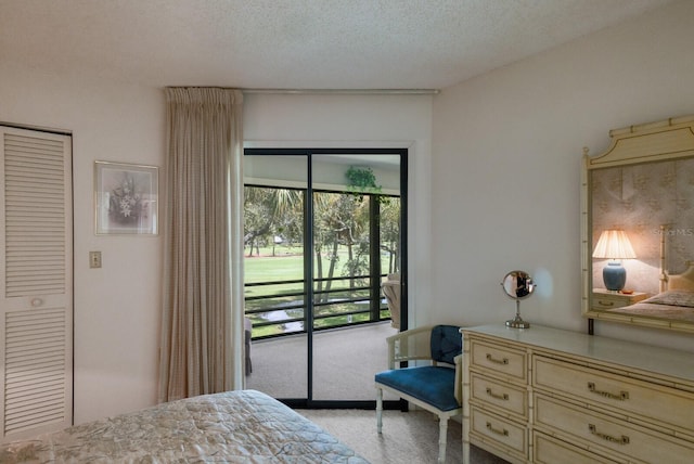 bedroom featuring a textured ceiling and access to exterior