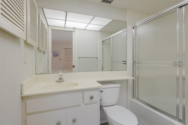 full bathroom with enclosed tub / shower combo, toilet, and vanity