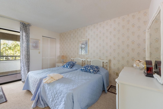 carpeted bedroom featuring a closet and a textured ceiling