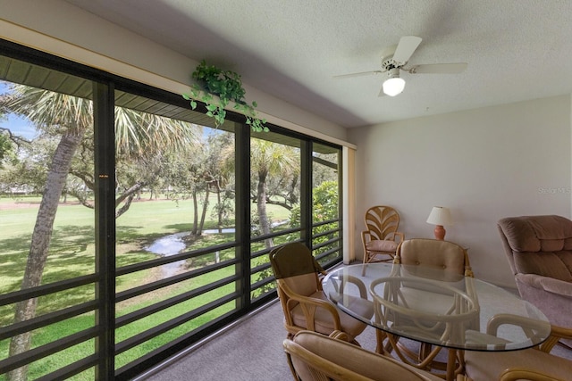 sunroom featuring ceiling fan