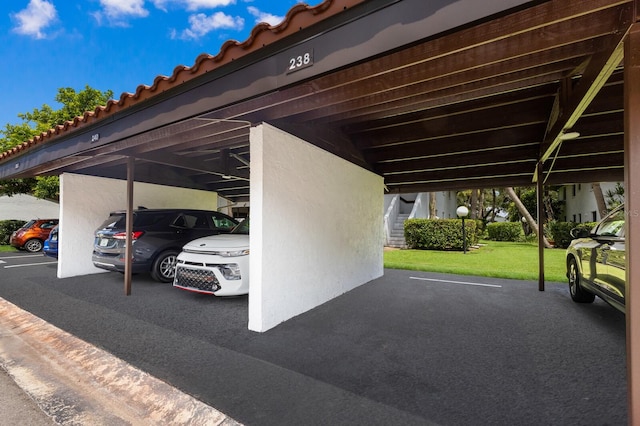 view of car parking with a yard and a carport