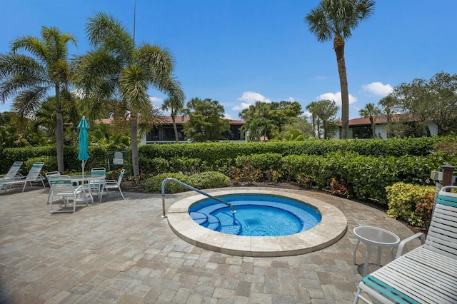 view of swimming pool with a community hot tub and a patio