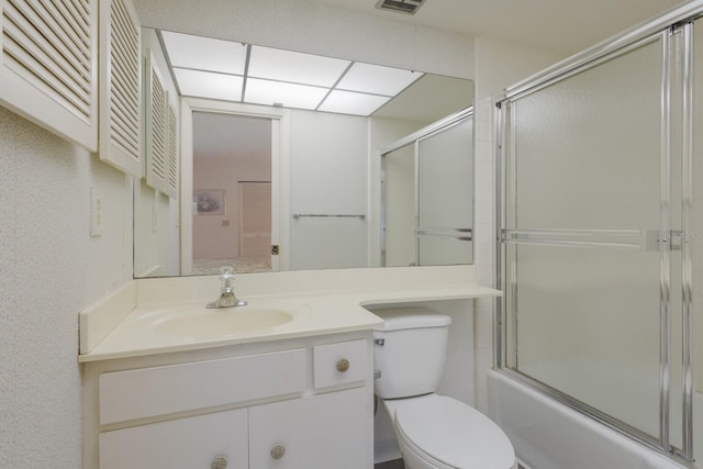 full bath with visible vents, shower / bath combination with glass door, vanity, and toilet